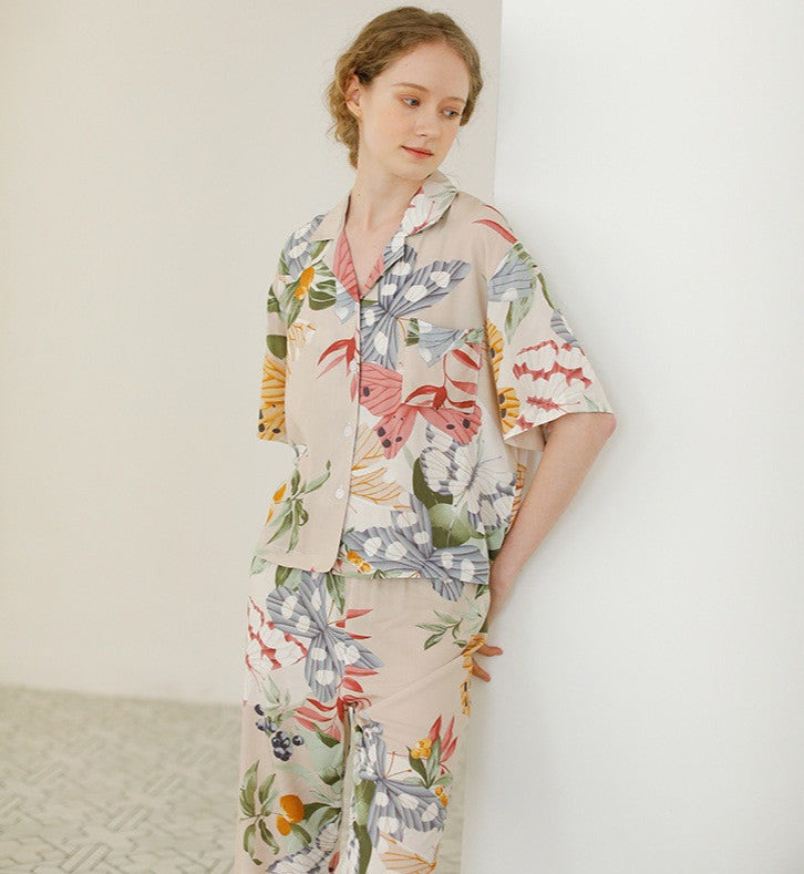 Beige women's pajamas with colorful flowers and butterflies in large print, comes in either shorts or trousers with a short sleeve button down top with lapel collar. Spring, Summer Ladies Pajamas, breathable, comfortable and soft women's pajamas, loungewear, sleepwear.