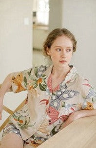 Beige women's pajamas with colorful flowers and butterflies in large print, comes in either shorts or trousers with a short sleeve button down top with lapel collar. Spring, Summer Ladies Pajamas, breathable, comfortable and soft women's pajamas, loungewear, sleepwear.