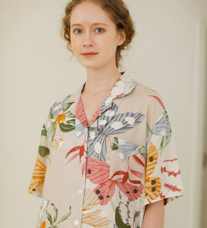 Beige women's pajamas with colorful flowers and butterflies in large print, comes in either shorts or trousers with a short sleeve button down top with lapel collar. Spring, Summer Ladies Pajamas, breathable, comfortable and soft women's pajamas, loungewear, sleepwear.