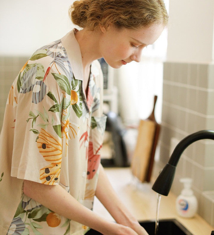 Beige women's pajamas with colorful flowers and butterflies in large print, comes in either shorts or trousers with a short sleeve button down top with lapel collar. Spring, Summer Ladies Pajamas, breathable, comfortable and soft women's pajamas, loungewear, sleepwear.