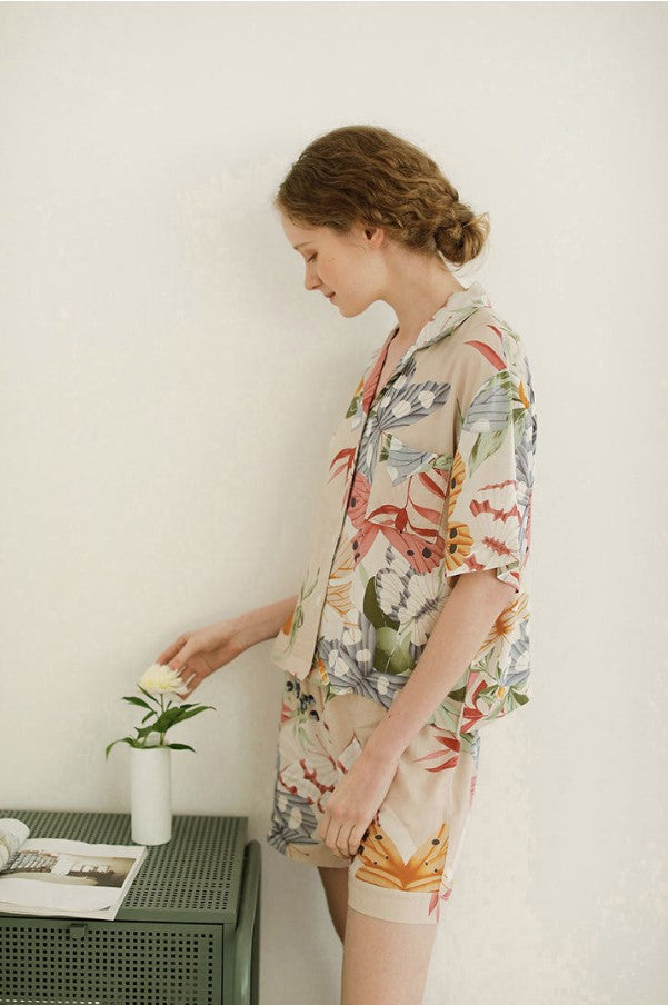 Beige women's pajamas with colorful flowers and butterflies in large print, comes in either shorts or trousers with a short sleeve button down top with lapel collar. Spring, Summer Ladies Pajamas, breathable, comfortable and soft women's pajamas, loungewear, sleepwear.