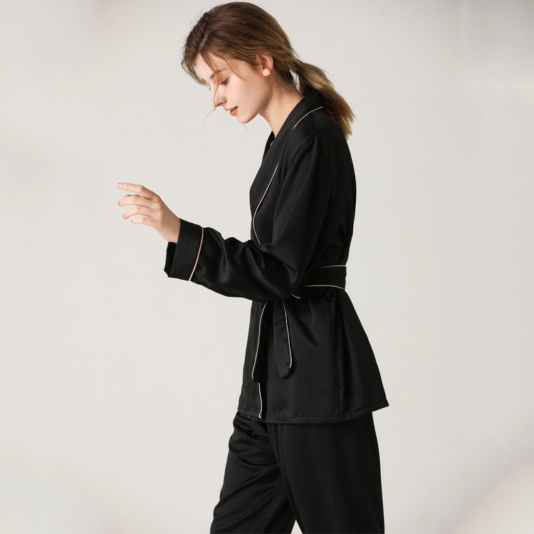 Black satin pajama set with wrap around top and elastic waist band and piping