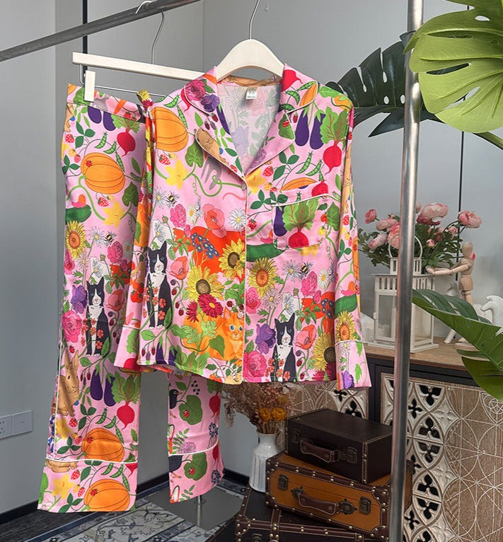 Pink women's pajamas, flower and vegetable garden with kitty cat and a red fox surrounded by flowers and vegetables. Women's pajamas come in either shorts or trousers with tie waist and button down top with long or short sleeves. Soft comfortable, breathable, colorful, cheerful women's pajamas